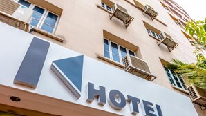 A hotel sign with a modern design, featuring a large arrow and the word "HOTEL" in bold letters. - K HOTEL 12 (Singapore)