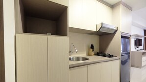 A modern kitchen with a stainless steel sink, a gas stove, and a built-in oven.