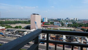 A cityscape with a prominent building, a bridge, and a highway.
