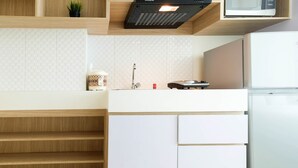 A modern kitchen with a microwave, stove, and sink.
