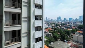 A high-rise building with multiple balconies and air conditioning units. - Central Jakarta Studio Apartment At Tamansari Sudirman (Jakarta)