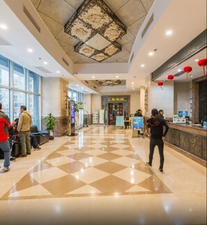 A hotel lobby with a check-in counter, seating area, and a patterned ceiling. - Shanghai Yueyi Apartment Hotel (Shanghai)