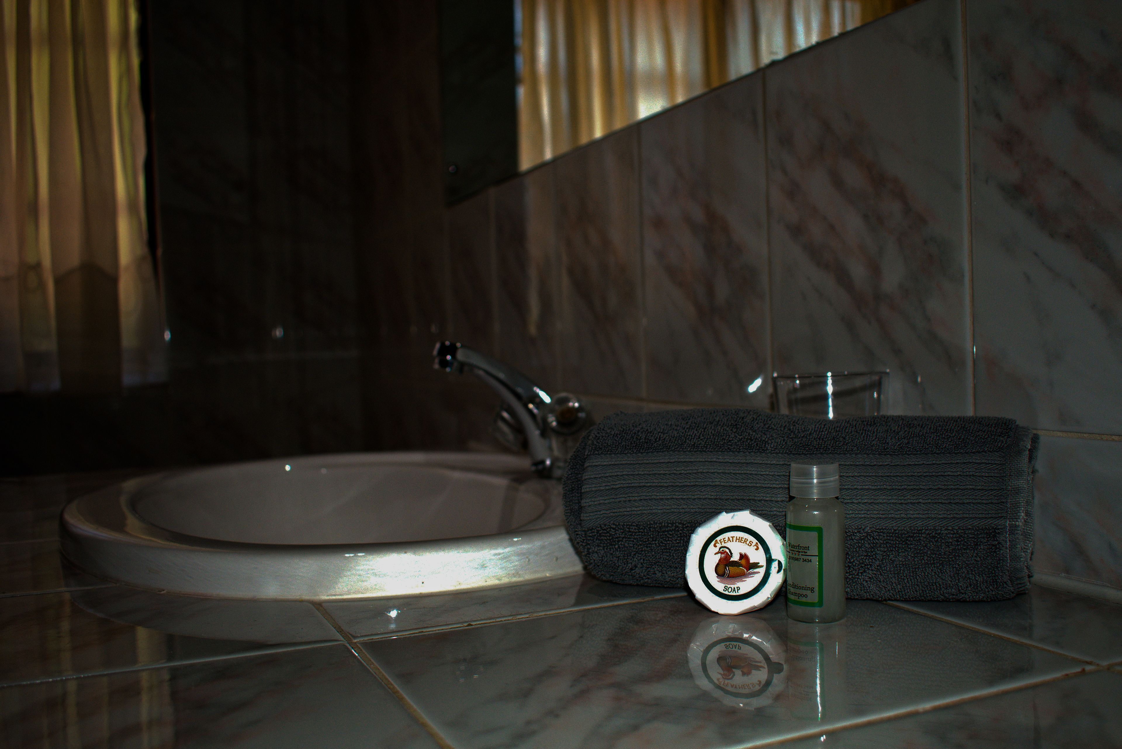 deep-soaking bathtub, hydromassage showerhead, towels