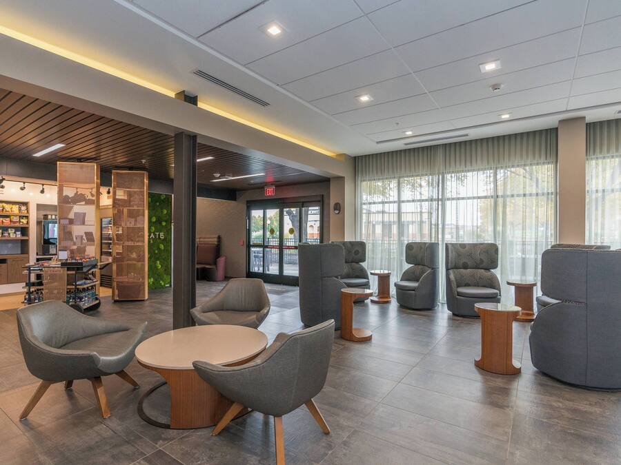 A modern lounge area with seating and a snack bar.