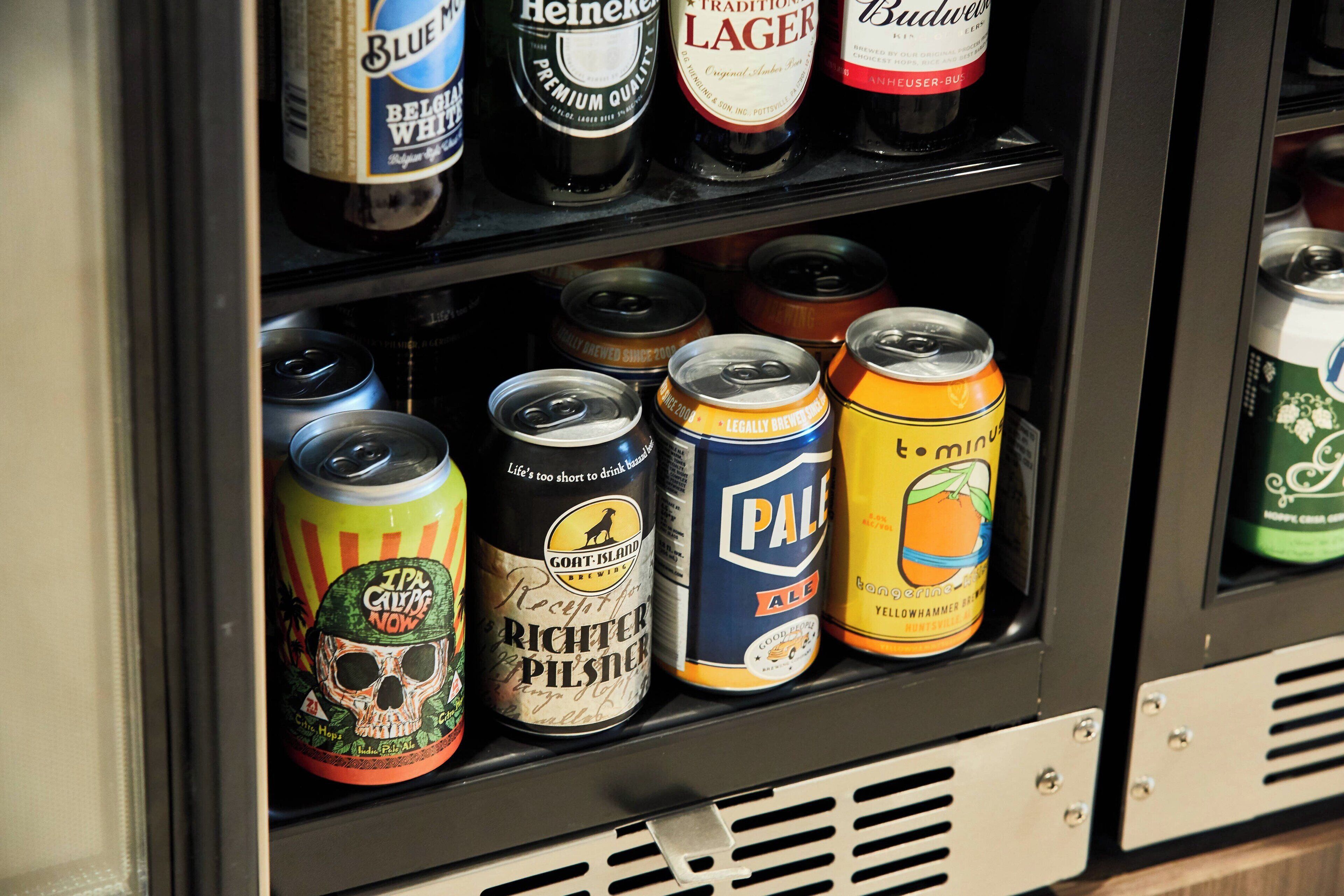 A refrigerated display case with various beer cans and bottles.