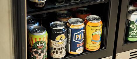 A refrigerated display case with various beer cans and bottles.