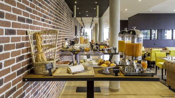 A breakfast buffet with various food items and a coffee station.