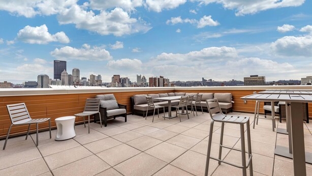 A rooftop terrace with outdoor seating, a city skyline view, and a clear sky. - Comfort Inn & Suites Pittsburgh-Northshore (Pittsburgh)