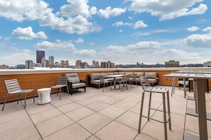 A rooftop terrace with outdoor seating, a city skyline view, and a clear sky. - Comfort Inn & Suites Pittsburgh-Northshore (Pittsburgh)