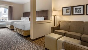 A hotel room with two beds, a sofa, a lamp, and framed pictures on the wall. - Comfort Inn & Suites Pittsburgh-Northshore (Pittsburgh)