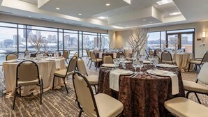 A conference room with multiple tables, chairs, and large windows offering a city view. - Comfort Inn & Suites Pittsburgh-Northshore (Pittsburgh)