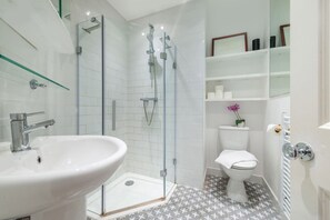 Shower, hair dryer, towels, shampoo