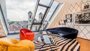 A modern room with a large skylight, a zebra-patterned rug, and a city view. - Luxury Residence near Parliament (Vienna)