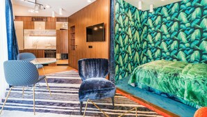 A modern bedroom with a large bed, a TV, a wooden wardrobe, and a patterned wall. - Luxury Residence near Parliament (Vienna)