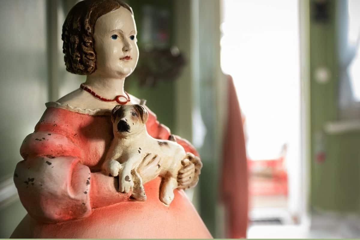 A statue of a woman holding a dog.