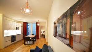 A modern apartment with a dining area, kitchen, and living room. - Premium Residence near Parliament (Vienna)