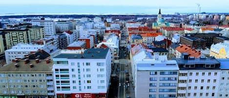 A cityscape with a variety of buildings, including a prominent white building with a red sign that reads "Asia Market".