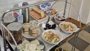 A food cart with various items including bread, cheese, and fruits. - Eccelsoleccese (Lecce)
