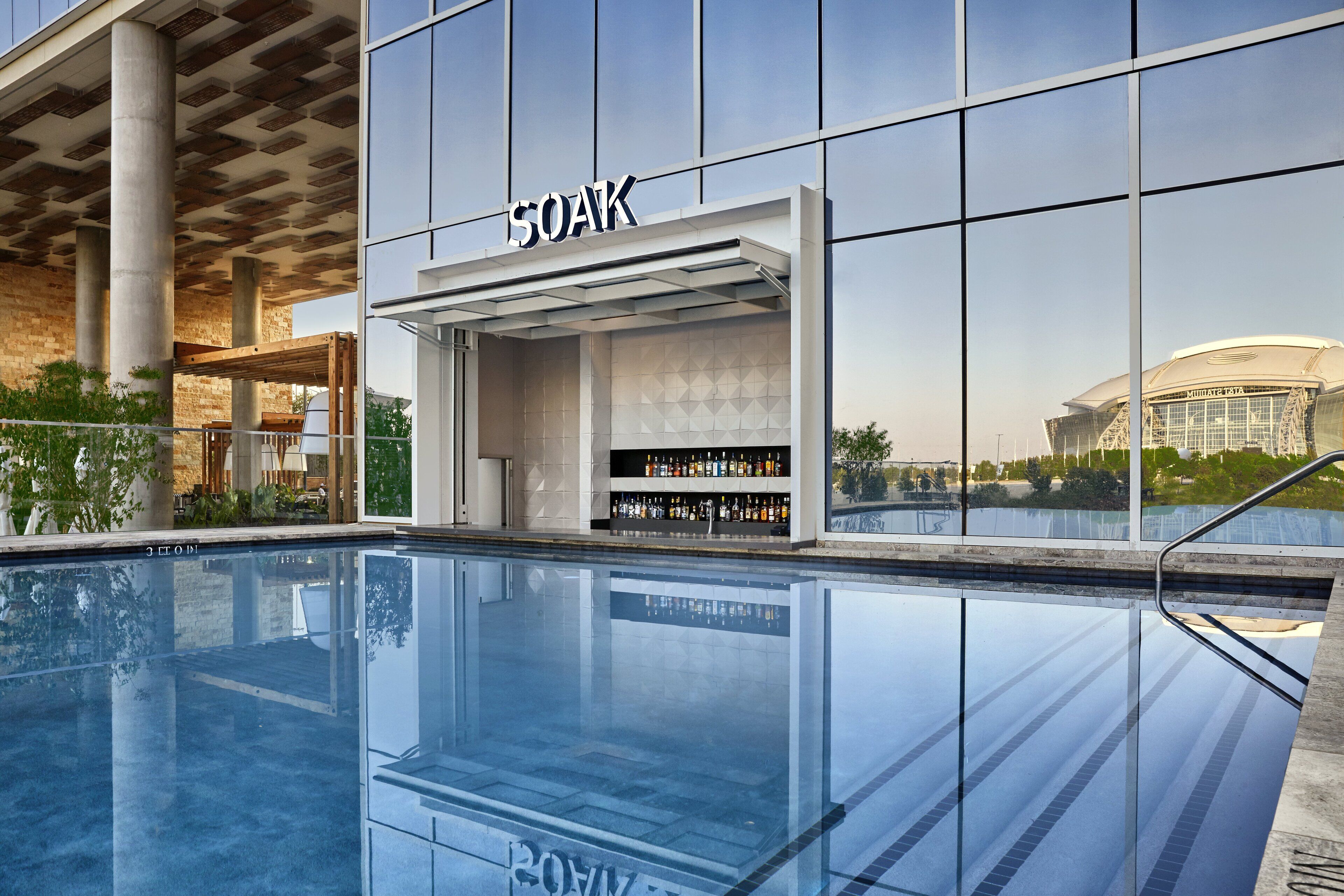 A modern building with a bar named 'SOAK' and a pool area.