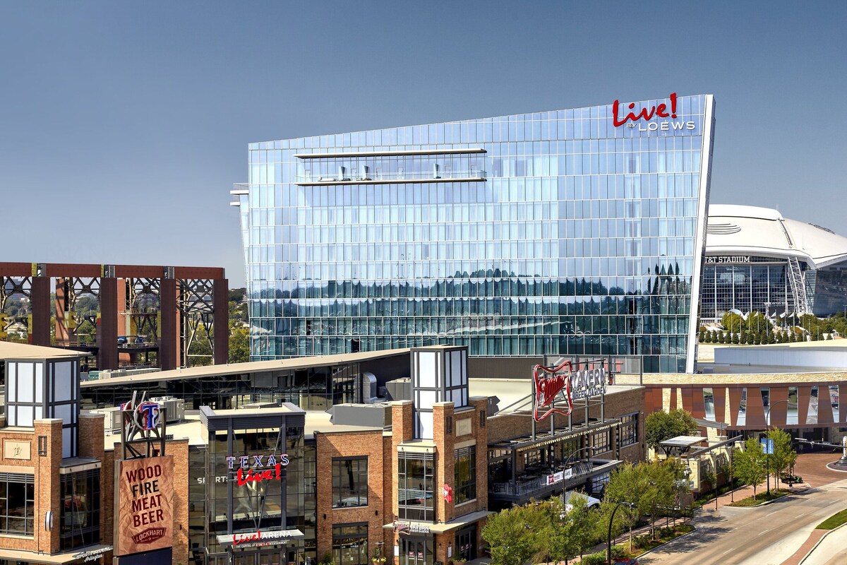 A modern hotel with a glass facade and a prominent 'Live!' sign.