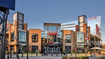 A modern building with a prominent "Texas Live!" sign, featuring a sports and social area, a restaurant, and a garden.