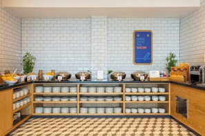 A buffet area with a variety of food options, including cereal, fruits, and a sign indicating bacon availability. - Holiday Inn Express Bridgwater M5, Jct. 24 by IHG (Bridgwater)