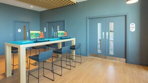 A modern office space with a long table, four chairs, and two computer monitors. - Holiday Inn Express Bridgwater M5, Jct. 24 by IHG (Bridgwater)
