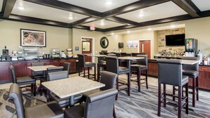 A hotel lobby with a bar area, seating arrangements, and a kitchen in the background. - Cobblestone Hotel and Suites Torrington (Torrington)