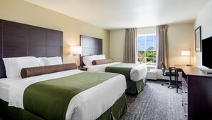 A hotel room with two beds, a desk, a chair, and a TV. - Cobblestone Hotel and Suites Torrington (Torrington)