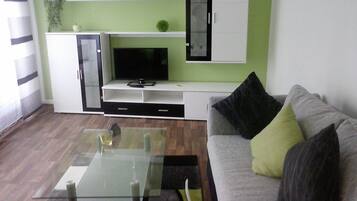 Deluxe Apartment | Living area | Flat-screen TV
