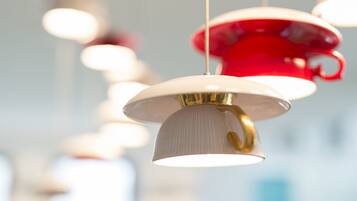A series of hanging pendant lights with a white and red color scheme.