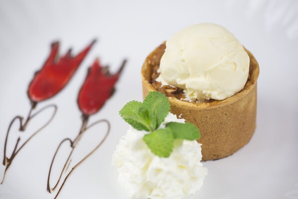 A dessert with ice cream in a pastry, accompanied by whipped cream and mint leaves. - Hotel Vabank (Golub-Dobrzyń)