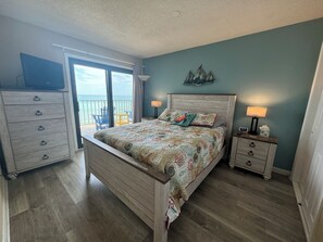 A bedroom with a bed, a dresser, a nightstand, and a view of the ocean. - Beautiful Oceanfront 2 Bedroom BOTH OCEANFRONT 2 Bath Condo With AMAZING Views  (North Myrtle Beach)