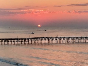A pier extending into calm waters during sunset. - Beautiful Oceanfront 2 Bedroom BOTH OCEANFRONT 2 Bath Condo With AMAZING Views  (North Myrtle Beach)
