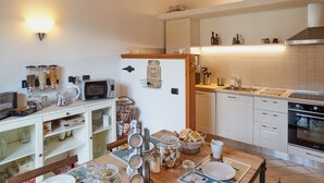A compact kitchen with white cabinets, a microwave, a toaster, and a sink. - bcube - bed and breakfast in the village (Pavia)