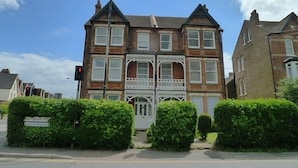 A Victorian-style building with a symmetrical facade, multiple windows, and a central entrance with a white porch. - Lovely Light, Spacious Flat With Sea View (Herne Bay)