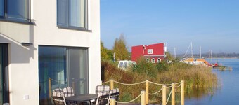 Modern holiday home directly in Hainer lake with boat