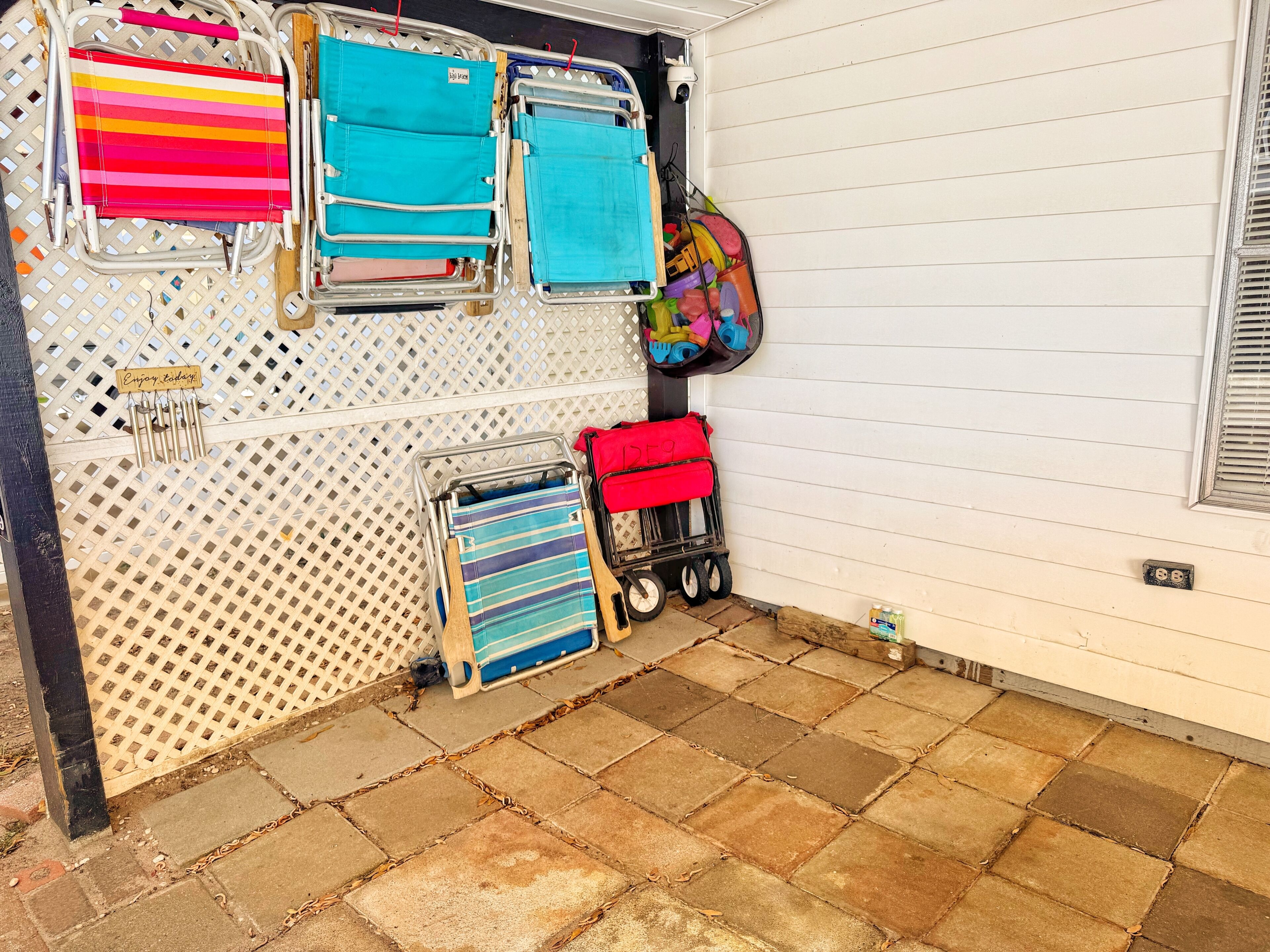 A storage area with various bags and a small cart.