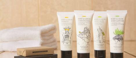 Four tubes of Cascadia Soapery products and two soap bars on a bathroom counter.