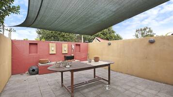 A patio area with a table, chairs, and outdoor decor.