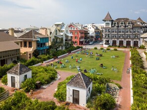 A courtyard with bicycles and people, surrounded by colorful buildings.