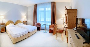 A hotel room with a double bed, a desk with a chair, a television, and a wardrobe. - Regiohotel Wittekind Burg (Burg)