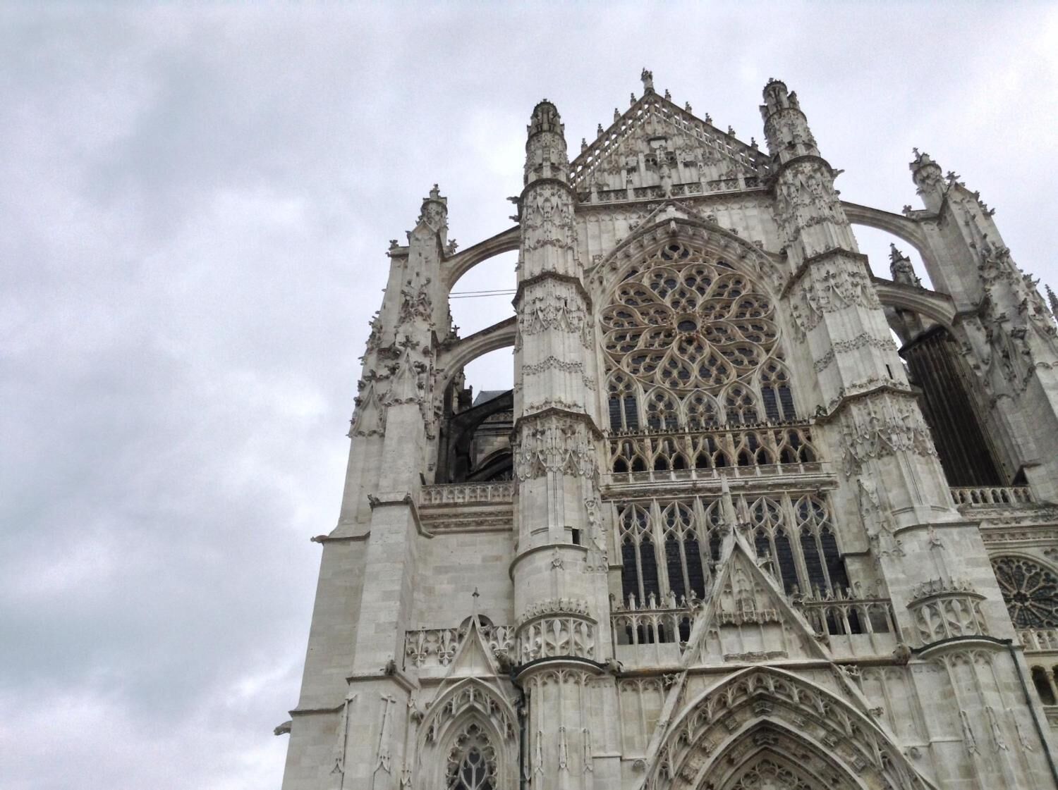 A Gothic cathedral with intricate stonework, large rose windows, and pointed arches.