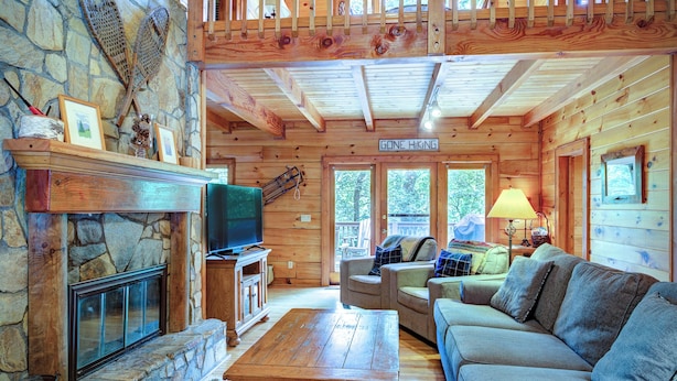 A cozy cabin interior with a stone fireplace, wooden furniture, and a 'Gone Hiking' sign. - Relaxing, Cozy, Beautiful 3 BR Log Cabin in Blowing Rock/Boone NC (Blowing Rock)
