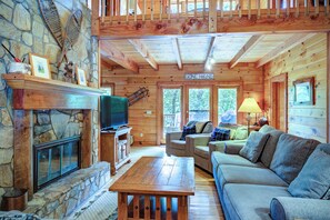 A cozy cabin interior with a stone fireplace, wooden furniture, and a 'Gone Hiking' sign. - Relaxing, Cozy, Beautiful 3 BR Log Cabin in Blowing Rock/Boone NC (Blowing Rock)