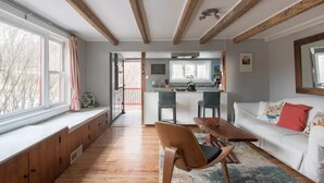 A modern interior with a kitchen, dining area, and seating space. - Modern Farmhouse on pristine private 12 Acres (Wallkill)