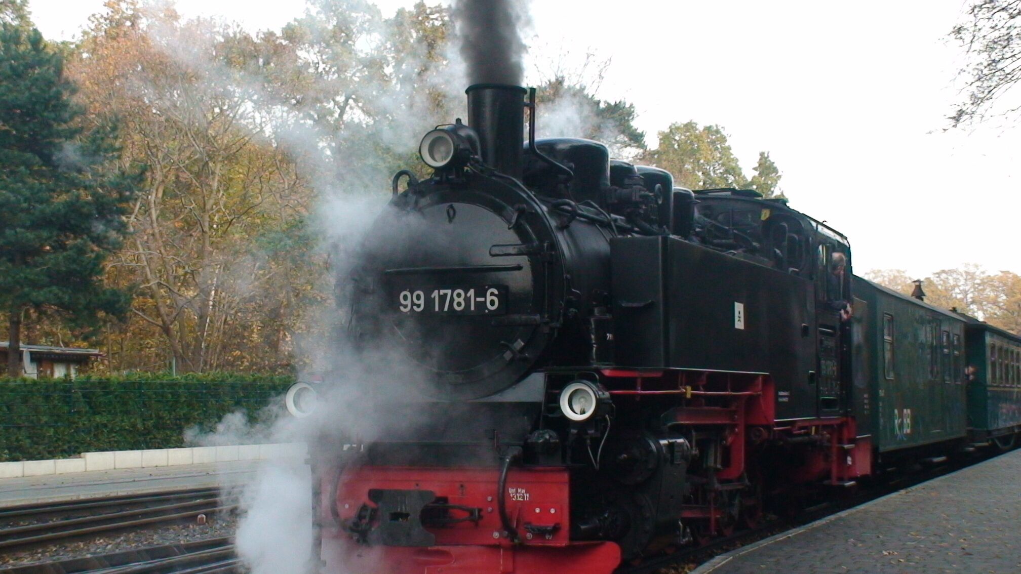 A steam locomotive with the number 99 1781-6 on the front, emitting steam, and positioned on a railway track.