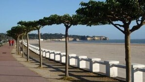 A coastal walkway with trees and white railings, leading to a beach. - Apart. w/ panoramic sea view facing beach for 6 people, Saint-Georges-de-Didonne (Saint-Georges-De-Didonne)