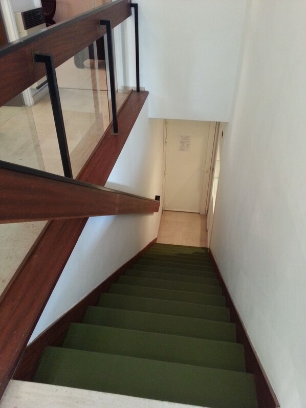 A staircase with wooden steps and a glass railing.
