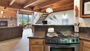 A kitchen with a stove, oven, and a view of the outdoors. - Snowflower 15: Mountain Views, Near Snowcreek Golf (Mammoth Lakes)